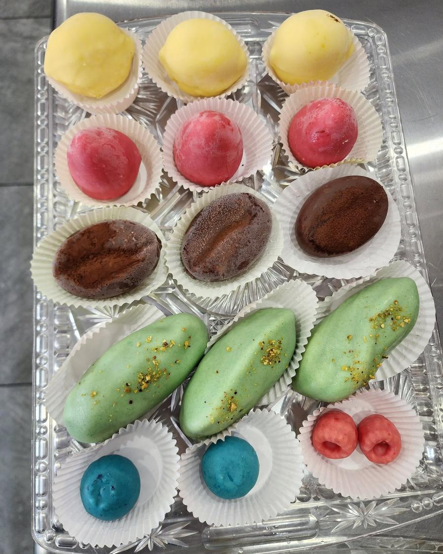 French petit fours in lemon, raspberry, chocolate and pistachio flavors