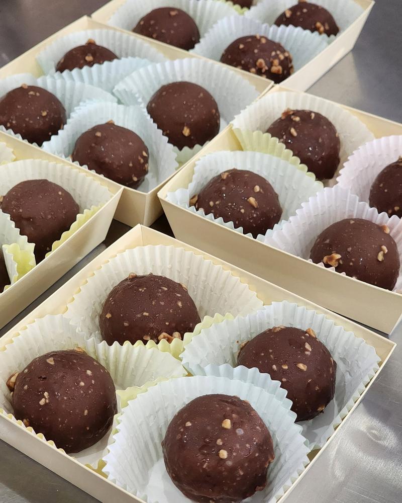 Chocolate hazelnut truffles in individual paper cups, boxed